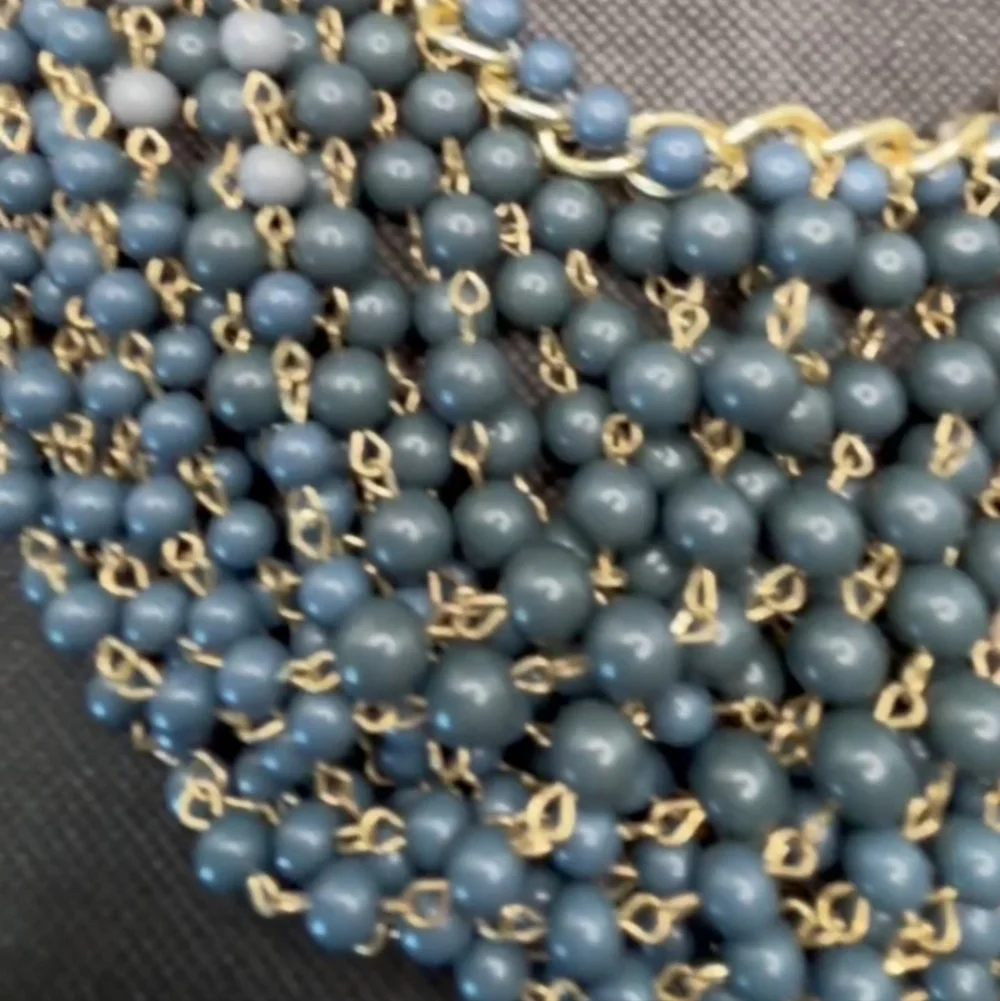 Gold plated cuban link chain with dangling graduated color jasper roundbeads